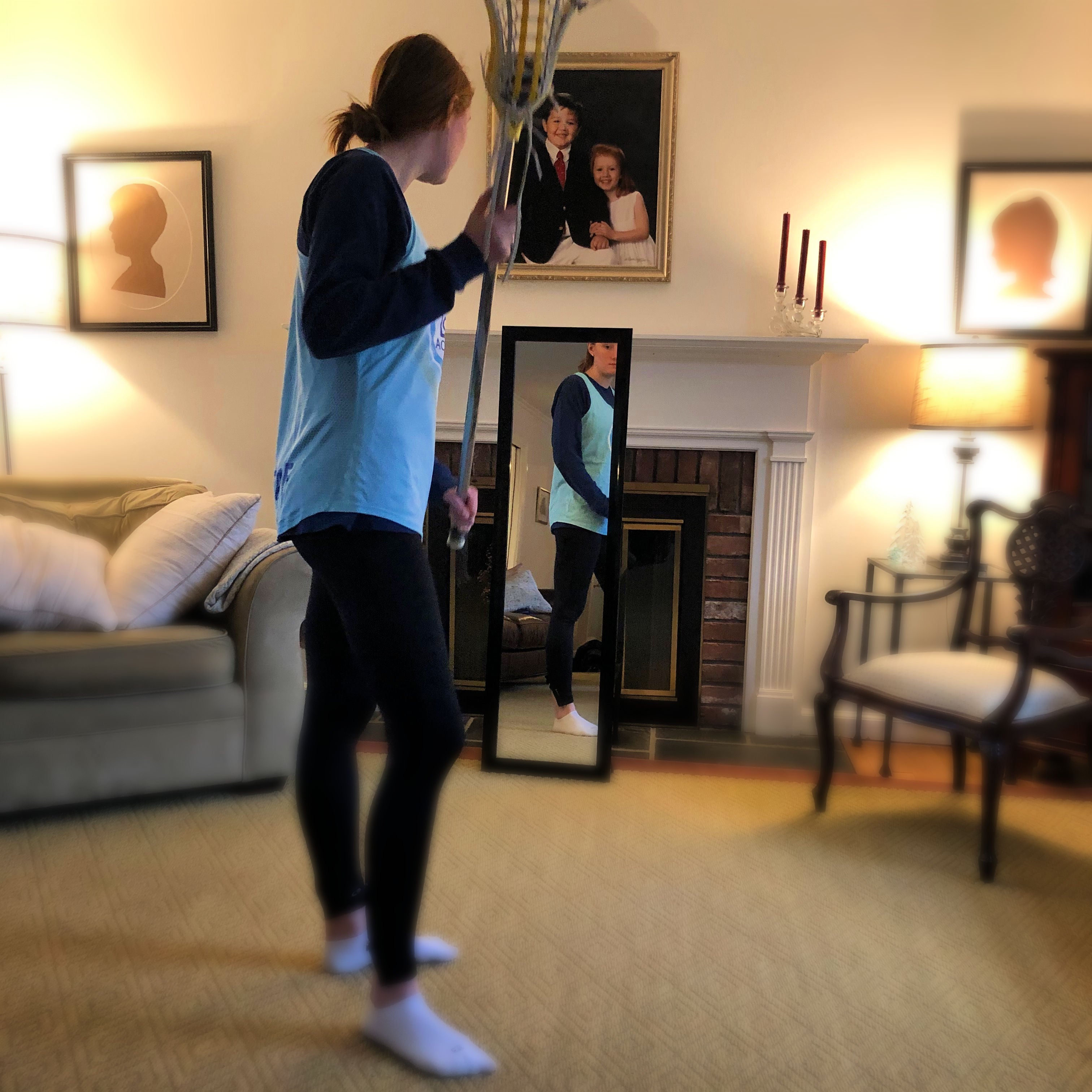 Coach Liza practices the Mirror lacrosse drill at home