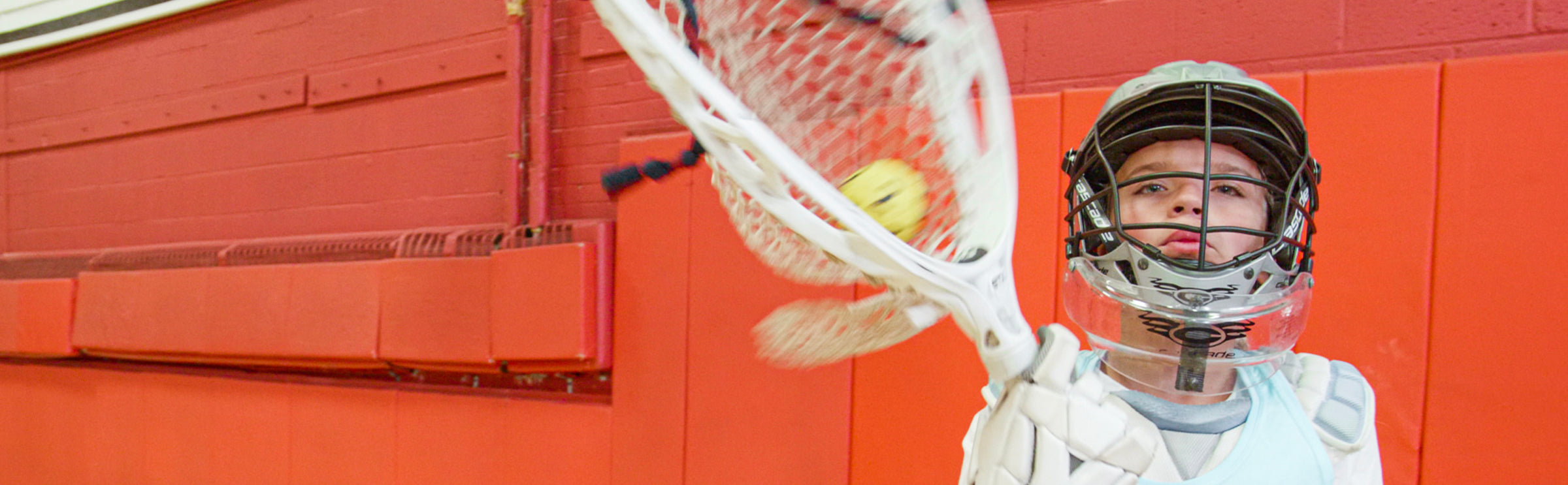 Lacrosse goalie training indoors using a Swax Lax Goalie training ball