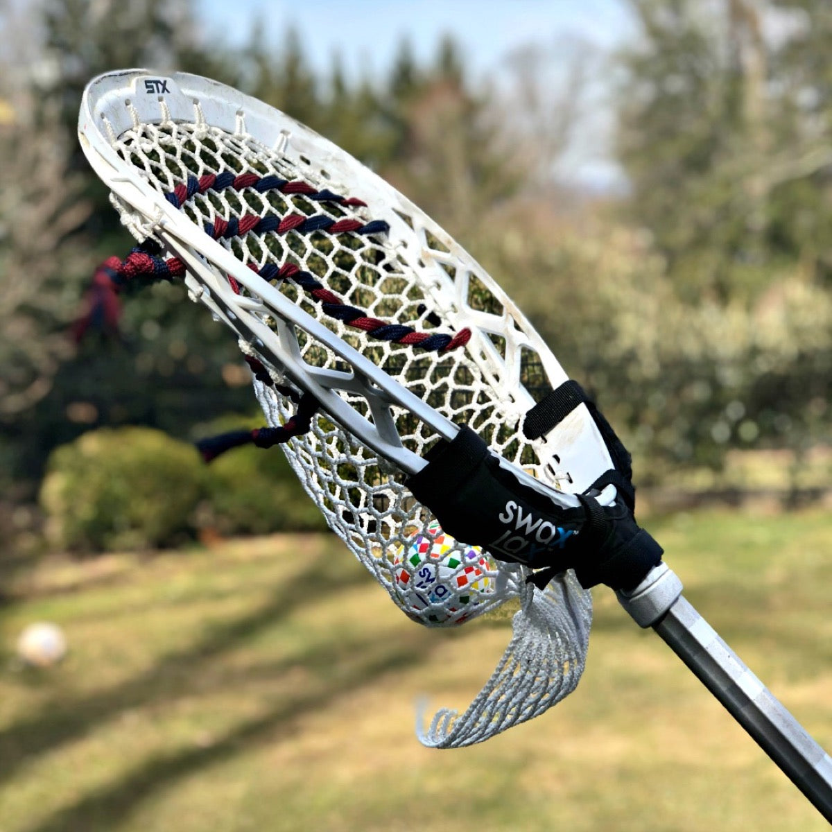 Swax Lax Power Weights shown on goalie lacrosse stick - side view