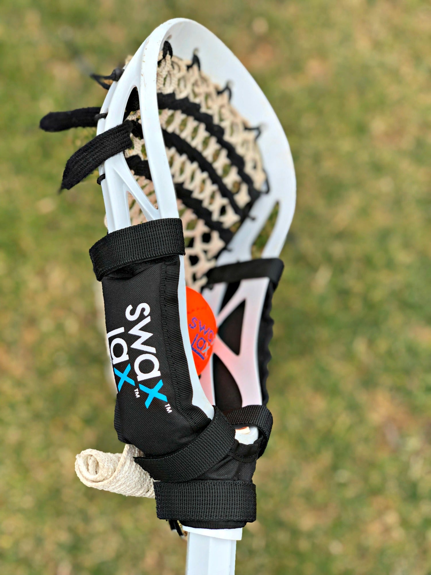 Swax Lax Power Weights shown on boy's lacrosse stick
